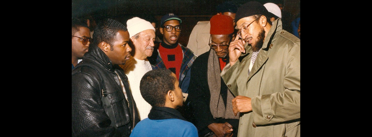 Imam Jamil confers with a man on the basketball court in Atlanta's West End Park